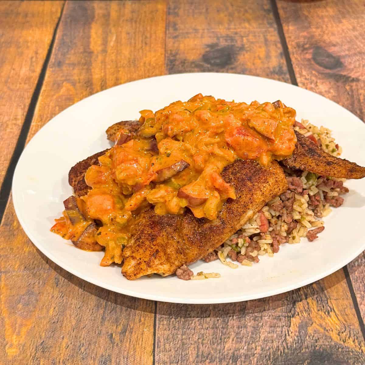 Blackened fish with cajun crawfish cream sauce and dirty rice